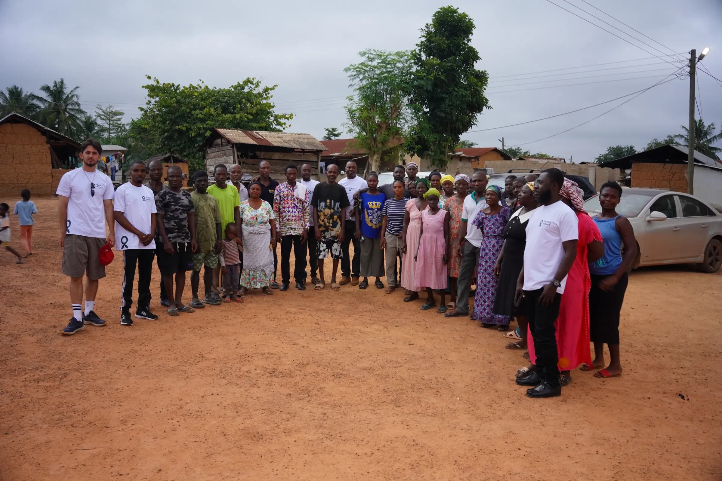 Residents of a project community gathered on the road outside